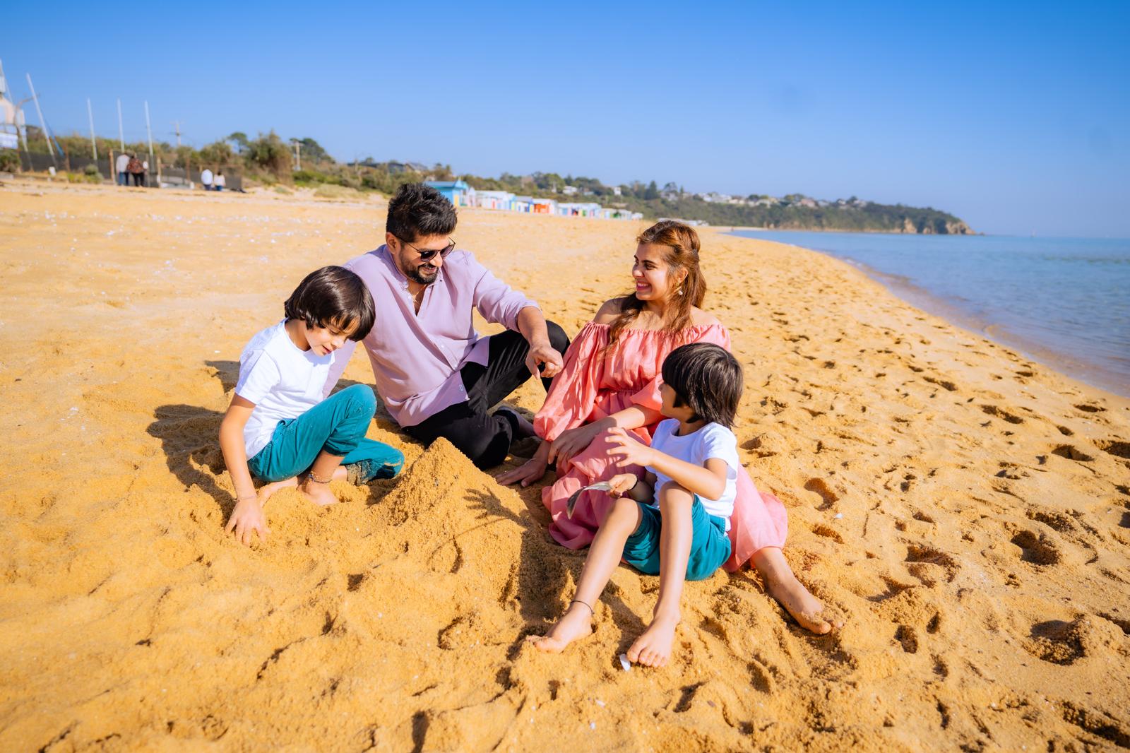 Family sitting together outdoors with child smiling